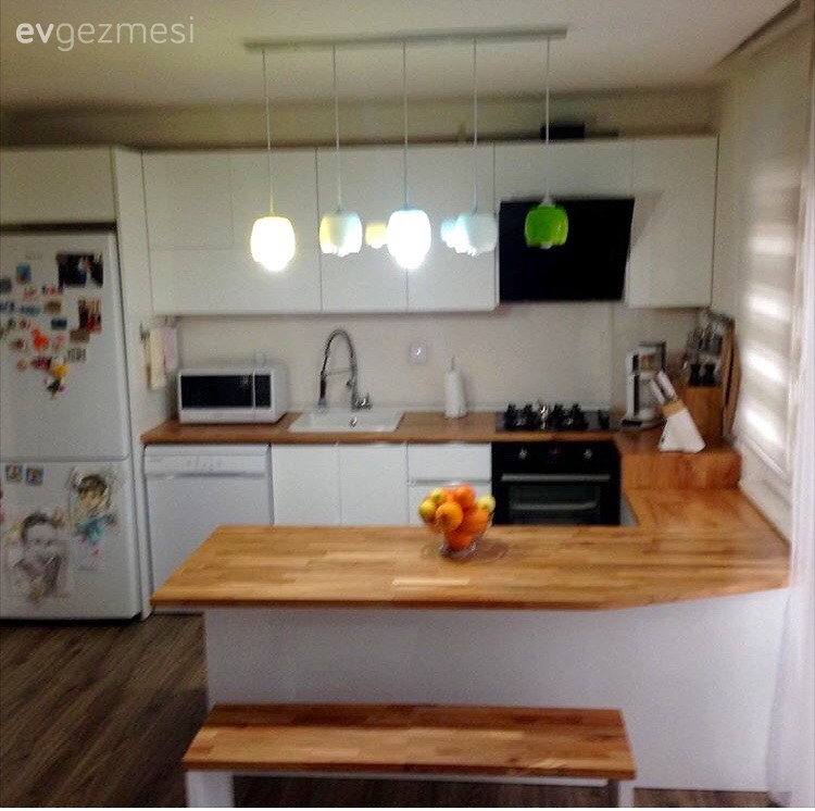 Bu mutfağın modern stil, kulpsuz dolapları ahşap tezgah ile doğal bir görünüm kazanıyor.