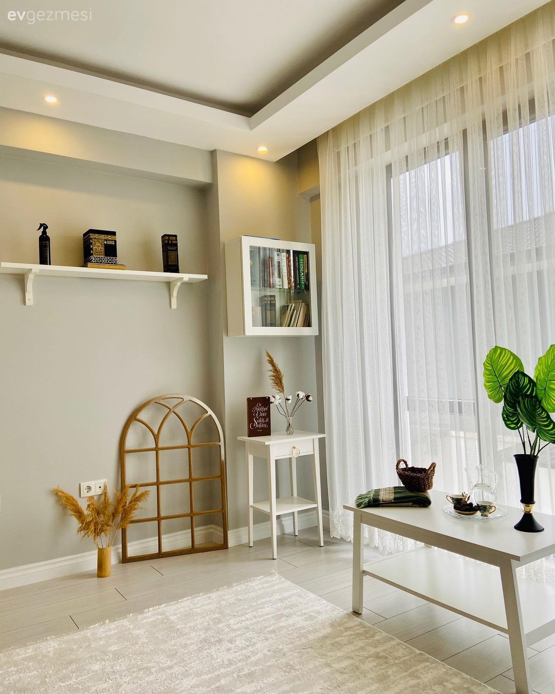 Oturma Odası, Krem duvar, Duvar rafı, Duvar dekorasyonu, Tül perde, Perde, Yan sehpa, Sehpa, Halı, Dekoratif Objeler, Vazo, Ev Aksesuar, Spot aydınlatma, Aydınlatma